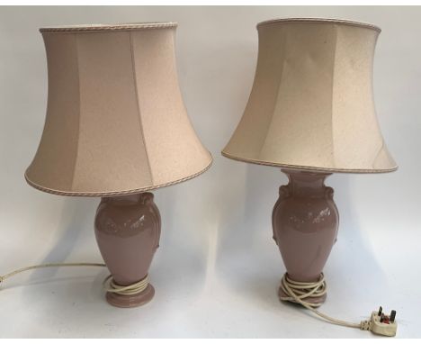 A pair of pink ceramic baluster form table lamps with shades 