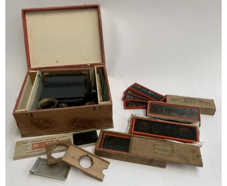 A magic lantern projector in case with numerous glass slides 