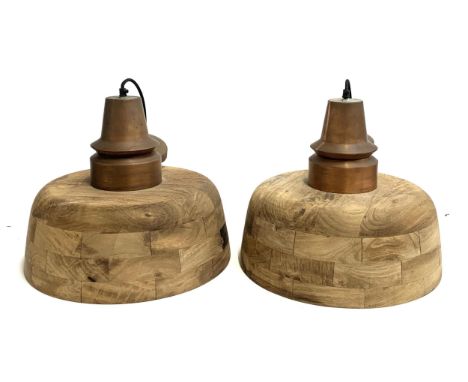 A pair of contemporary turned hardwood hanging light shades, brushed copper effect fittings, 40cmD 
