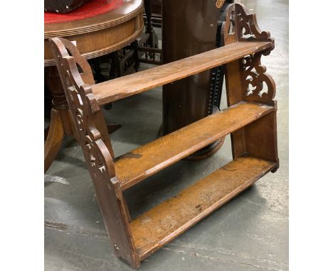 A 20th century oak wall shelf, with pierced ends, three shelves, 61cmW 