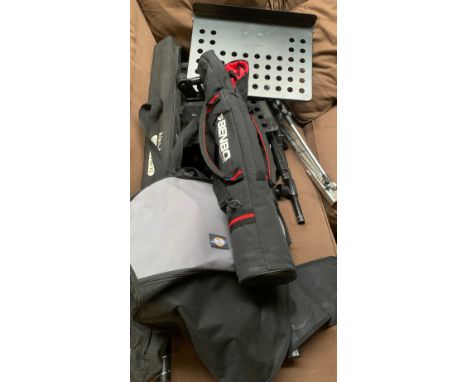A guitar case; several music stands; speaker stands; 