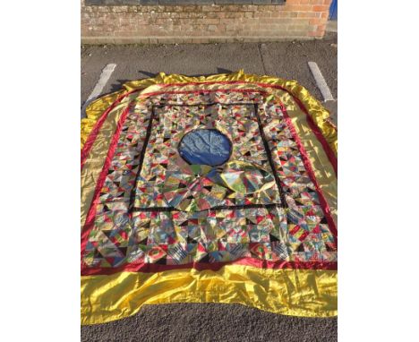 AN ANTIQUE PATCHWORK BED COVER, POSSIBLY 18th CENTURY&nbsp;made with brightly patterned silks and cottons, some backed with o