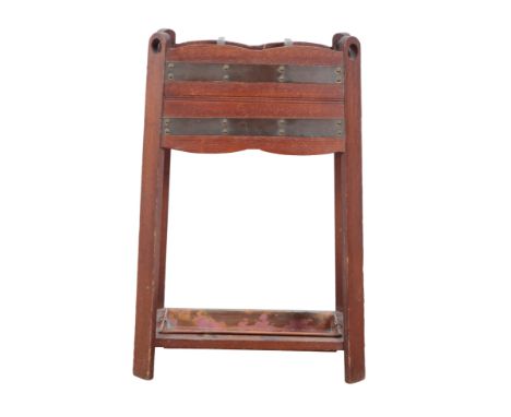 AN ARTS AND CRAFTS OAK AND COPPER-BANDED STICK STANDwith copper drip tray, the copper bands held with brass nails, 77cm high 