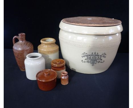 A DOULTON LAMBETH IMPROVED BREAD PANwith wooden cover, 29cm high, and a group of other kitchen stonewares