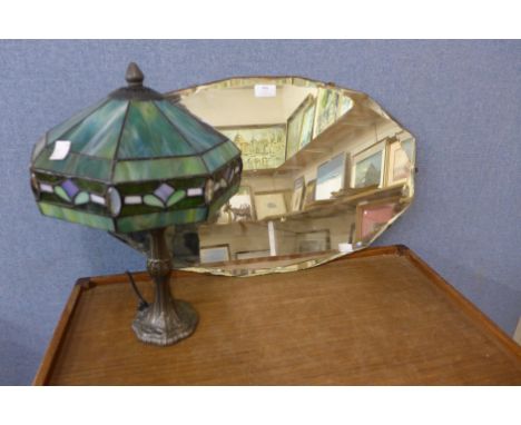 A bevelled edge mirror and a Tiffany style lamp 