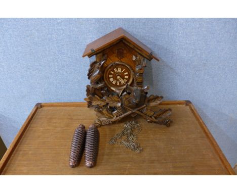 A Black Forest carved softwood cuckoo clock 