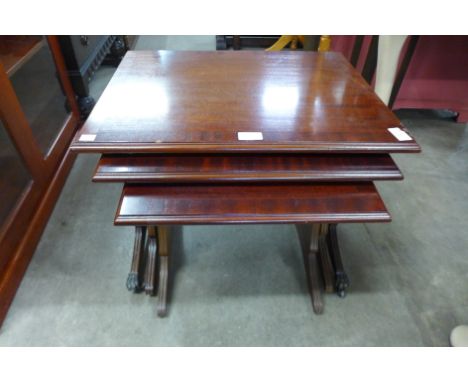 A mahogany nest of tables and a dark Ercol plate rack 