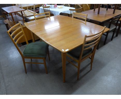 A Meredew light oak extending dining table and four chairs 