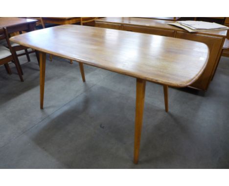 An Ercol Blonde elm and beech Windsor plank dining table 