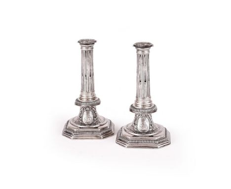 A PAIR OF QUEEN ANNE SILVER CANDLESTICKS RICHARD SYNG, LONDON 1703 With gadrooned and canted corner sconces, slightly taperin