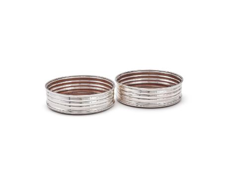 A PAIR OF GEORGE III IRISH SILVER MOUNTED WINE COASTERS MAKERS MARK R. ..., Dublin 1803 With ribbed bodies and turned wooden 
