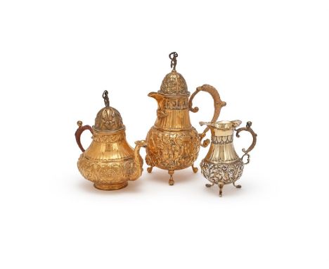 A DUTCH MATCHED SILVER GILT THREE PIECE TEA SETLATE 19TH CENTURY, .833 STANDARDThe tea pot with a figural terminal to the sta