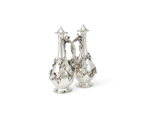A PAIR OF VICTORIAN SILVER BALUSTER CLARET JUGS STEPHEN SMITH & WILLIAM NICHOLSON, LONDON 1860 The domed covers with baluster