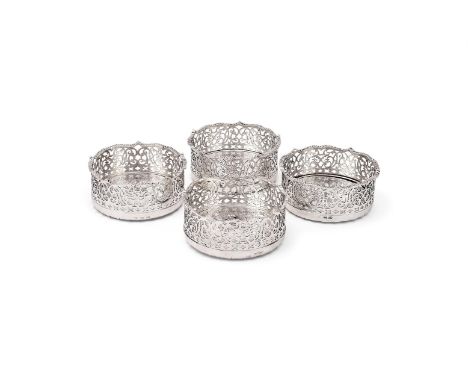 A SET OF FOUR VICTORIAN SILVER COASTERS EDWARD FARRELL, LONDON 1840 (2) AND 1842 (2) With gadrooned borders, pierced foliate 