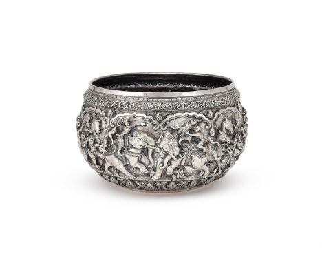 A BURMESE SILVER OFFERING BOWL EARLY 20TH CENTURY Chased with figures, birds and foliage, the base with a peacock 26cm (10in)