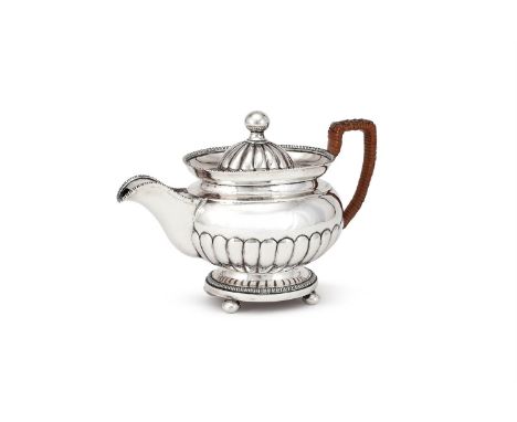 A MALTESE SILVER TEA POT GIOACCHINO LEBRUN, 1810 - 1820 MARK With an orb finial to the lobed domed cover, a wicker wrapped ha