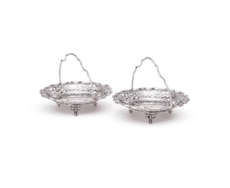 A PAIR OF EDWARDIAN SILVER SHAPED CIRCULAR BASKETS WALKER & HALL, SHEFFIELD 1904With loop handles, pierced foliate swag bands