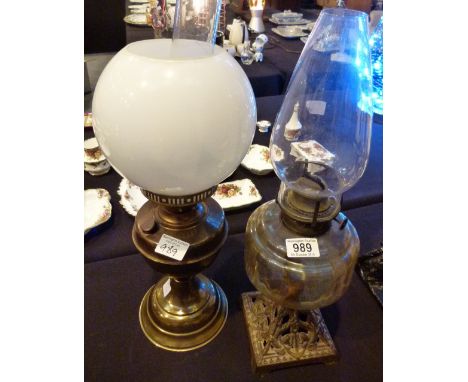 CAST METAL BASED OIL LAMP. Victorian cast metal based oil lamp and a further example