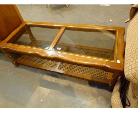 GLASS TOP CANE COFFEE TABLE. Glass top coffee table with cane shelf below 54 x 130