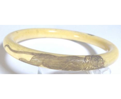 IVORY BANGLE. Hand carved antique ivory bangle with incised tiger decoration, D - 9cm