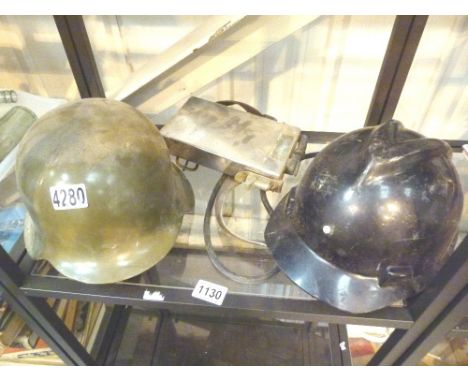 HELMETS. Fibreglass German helmet and a miners helmet with lamp and battery pack