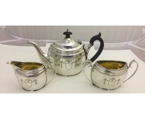 A hallmarked silver bachelor's tea set by Barnard & Sons retailed by Waring & Gillows in navette form with garland and urn br