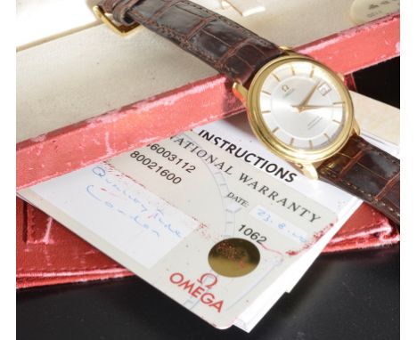 An 18ct gold Omega wristwatch - an automatic chronometer: gold case and silver dial with date aperture, HM to the back (with 