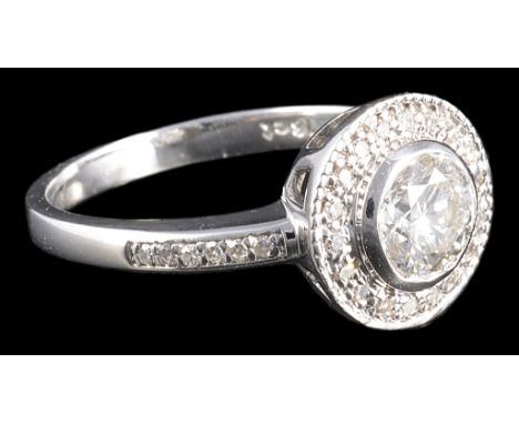 An 18ct diamond solitaire dress ring, central stone 0.72 ct (Scale Weight) set within a halo of diamonds and diamond set shou