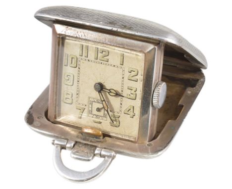 A silver cased travelling bedside clock with suspension ring and engine-turned decoration, maker's mark 'SSM' in a lozenge-sh