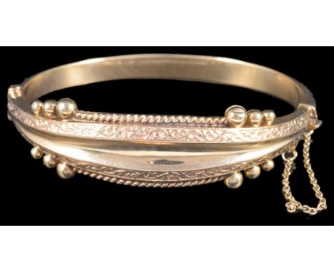A 9ct gold bangle with bead and rope design