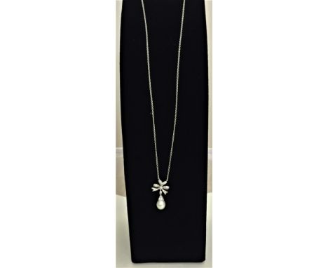 18ct chain & diamond set bow pendant with suspended pearl