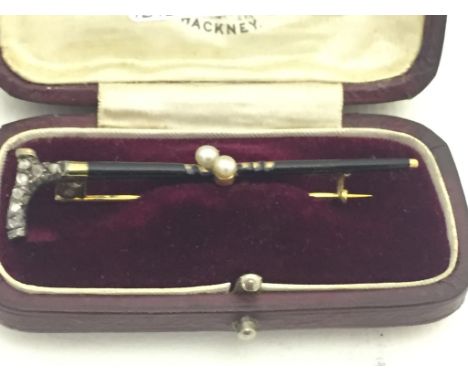 A cased Victorian walking stick brooch, with diamond set handle and black enamel (A/F) CONDITION REPORT: Damage to enamel and