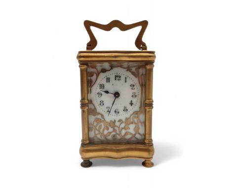 A French carriage clock, the enamel dial with cut out ormolu surround Condition Report:winds and ticks