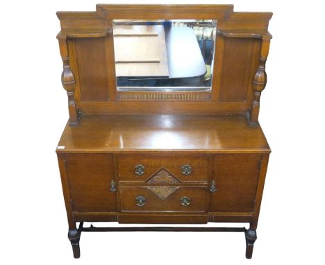 A 20th century mahogany mirror backed sideboard with bevelled glass mirror back over two central drawers flanked by cabinet d