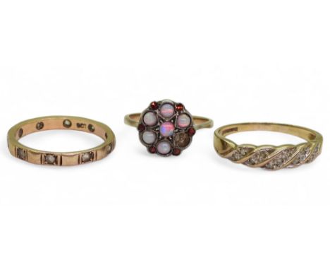 A 9ct gold twist pattern ring set with diamond accents, size P1/2, a 9ct clear gem set eternity ring, size M1/2, and a 9ct an
