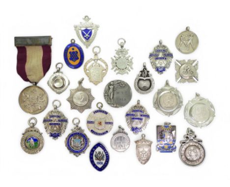 A collection of silver sporting fob medals, late-Victorian and later, including Devon County Golf Club, Sugg Cricket League, 