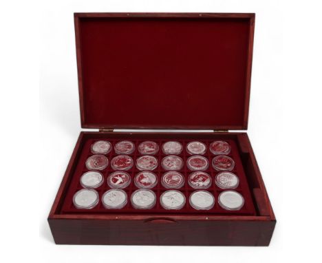 A lot comprising 144 1 oz silver coins various designs in a wood collector's case approximate weight 4000 grams Condition Rep