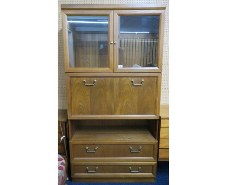 A 20th century mahogany wall display with two glazed doors over fall front compartment and two long drawers on plinth base, 1
