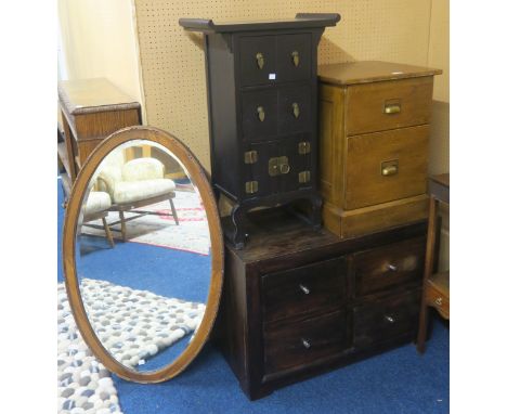 A lot comprising a contemporary two over two chest of drawers, two drawer filling cabinet, an oval wall mirror and an Orienta