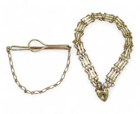 A 9ct gold tie clip and a 9ct gate bracelet with a heart shaped clasp, weight together 9gms Condition Report:Available upon r
