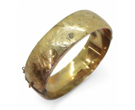 A 9ct gold engraved wide bangle, weight 23.6gms Condition Report:Available upon request