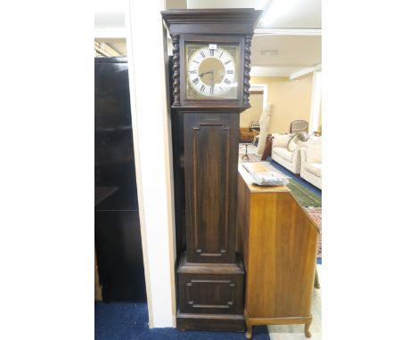 An early 20th century oak cased long case clock with brass face with silvered dial bearing Roman numerals, 188cm high and an 