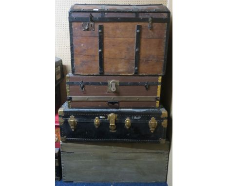 A lot comprising a wooden chest, metal bound travel trunk, wood bound travel trunk and a wood bound dome top travel trunk (4)