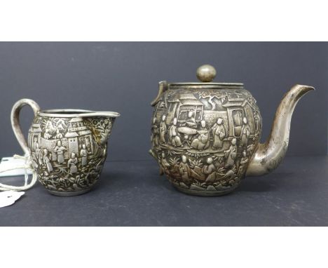 A 19th century Gem Woo Chinese canton silver tea pot, H.12cm, and matching jug, with broken handle, H.8cm, with repousse embo