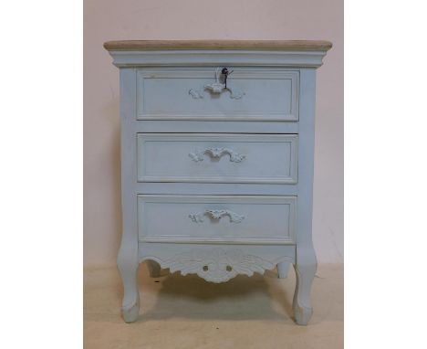 A Continental light blue painted bedside chest of 3 short drawers, with floral decorated shaped apron raised on cabriole legs