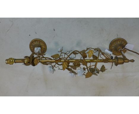 A gilt metal wall mounted light, with gilt metal leaf design to stem and having ceramic roses, H.60cm 