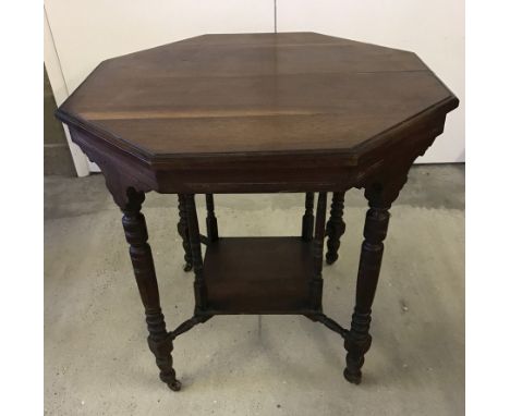 A Victorian octagonal occasional table. With turned legs and ceramic castors. Approx 74 x 72 tall.