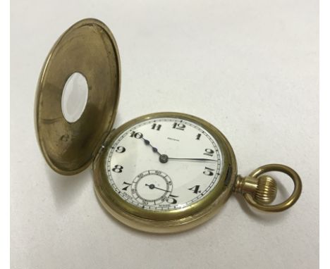 A vintage gold plated swiss made half hunter pocket watch. With white enamel face, in working order. Approx. 5cm diameter.