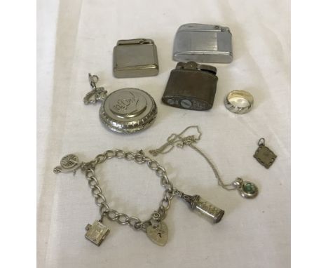 A small collection of silver jewellery and lighters. To include a silver charm bracelet with 4 charms and silver wedding band