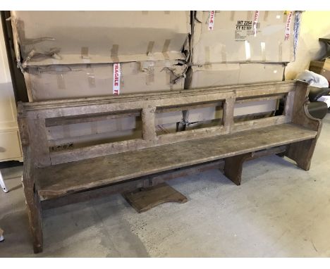 A vintage pine church pew with prayer book shelf to back.  Approx. 250cm long.